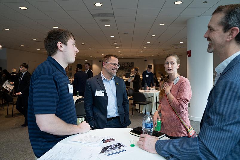 President Eric Boynton talking with alumni and student at Business Networking Summit 2024