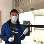 Jonathan Palmer ’19 in the chemistry lab holding pipet and vial