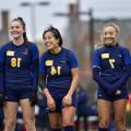 Lorraine Pedroza'24 (center) is introduced before the game against Washington University in St. Louis.