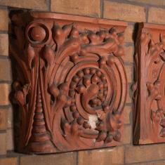 Many students, faculty, and alumni have walked past these intricately carved terracotta blocks, sunken into the brick wall of a well-used...